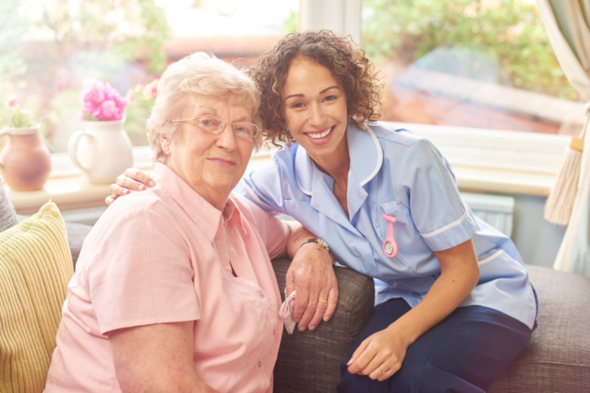 A caregiver spending time with an older woman at home